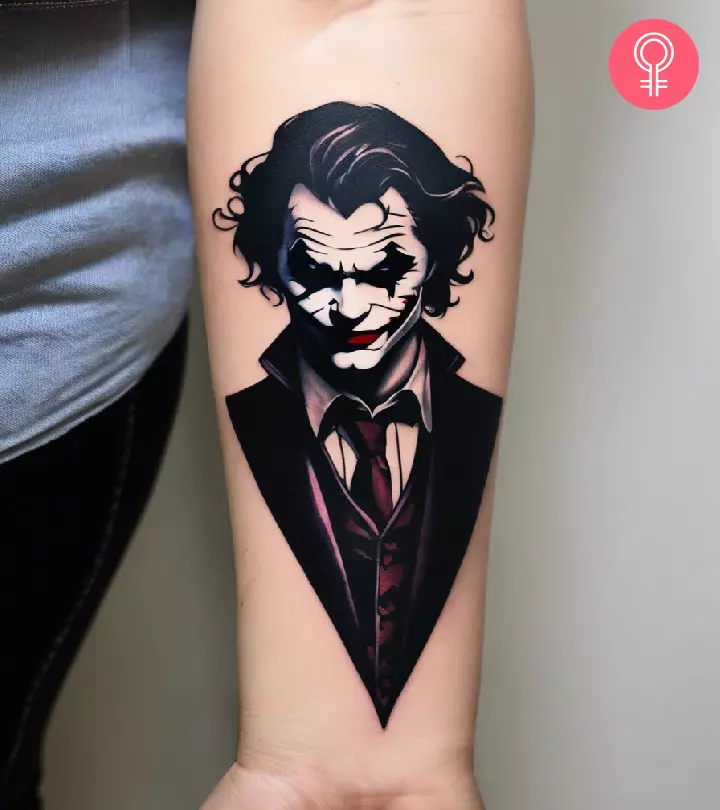 Woman with a joker tattoo on the lower arm