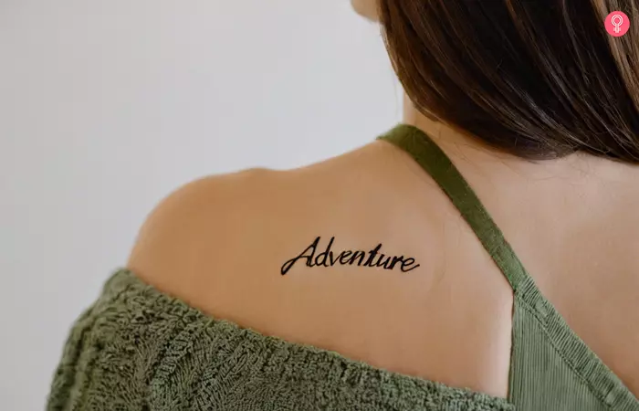 Woman with an ‘Adventure’ tattoo on her back shoulder