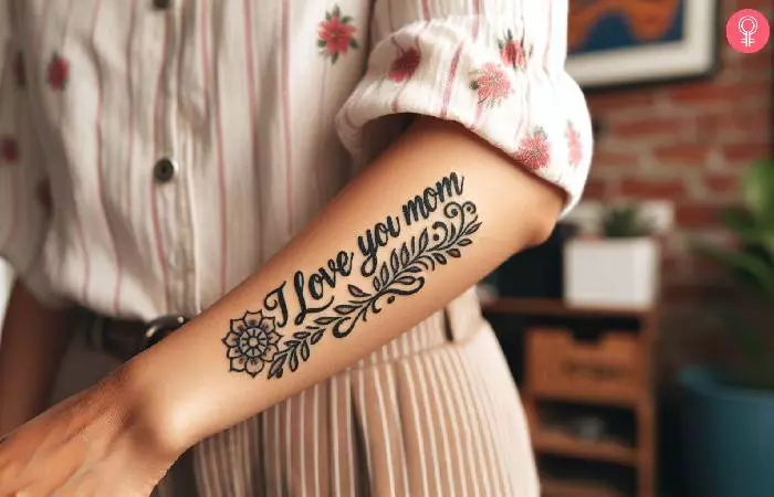Woman with an I Love You Mom tattoo on the forearm