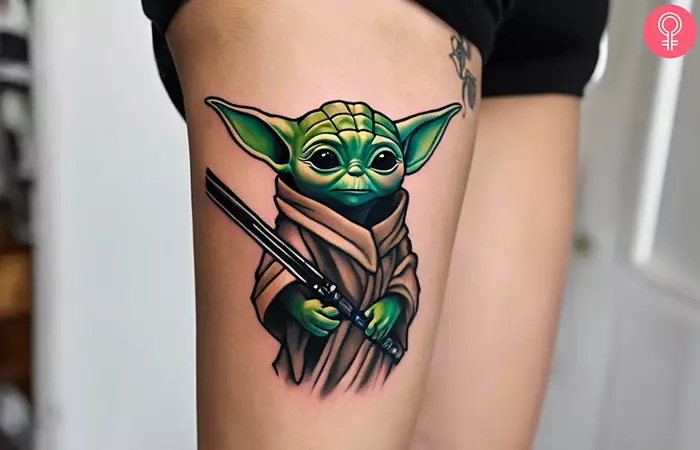 Yoda lightsaber tattoo on the thigh