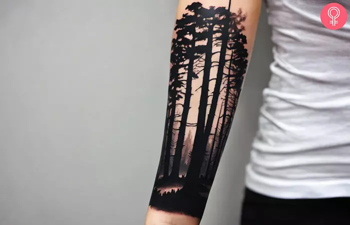 dark forest tattoo on the upper arm
