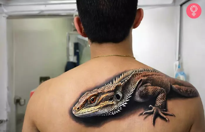 man with a 3D bearded dragon tattoo on his arm