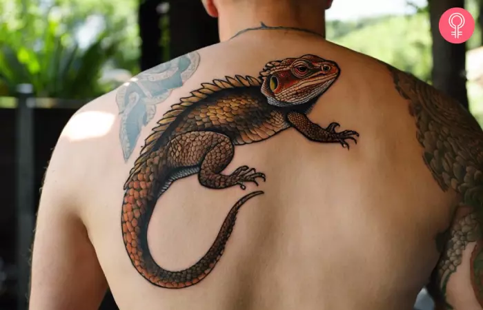 man with a traditional bearded dragon tattoo on his back
