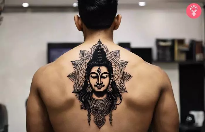 man with an ancient Hindu tattoo on his back