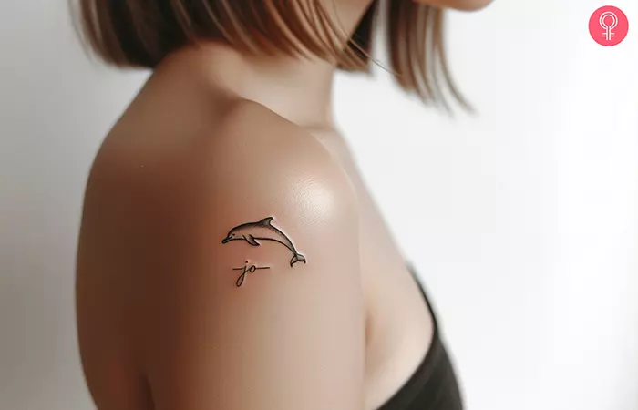 memorial dolphin tattoo on the upper arm