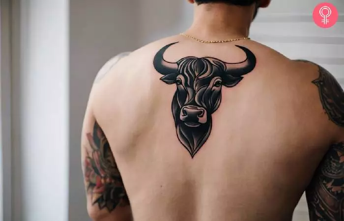 A man with a Spanish bull tattoo on his upper back