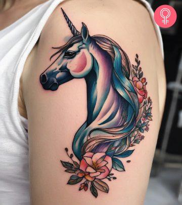 A woman with a unicorn tattoo on her upper arm