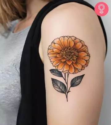 A woman with a chrysanthemum flower tattoo on her upper arm
