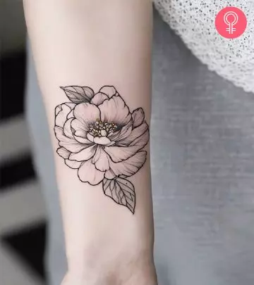 A victory tattoo on the upper arm of a woman