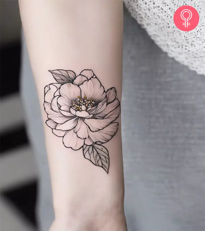 An outlined peony tattoo on the forearm