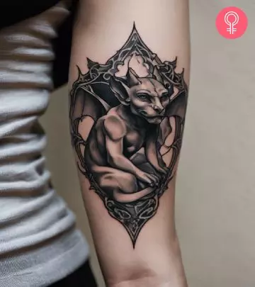 A gargoyle tattoo design on the arm of a woman