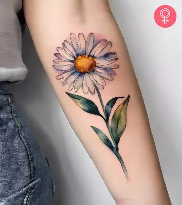 Woman with a delphinium tattoo on the upper arm