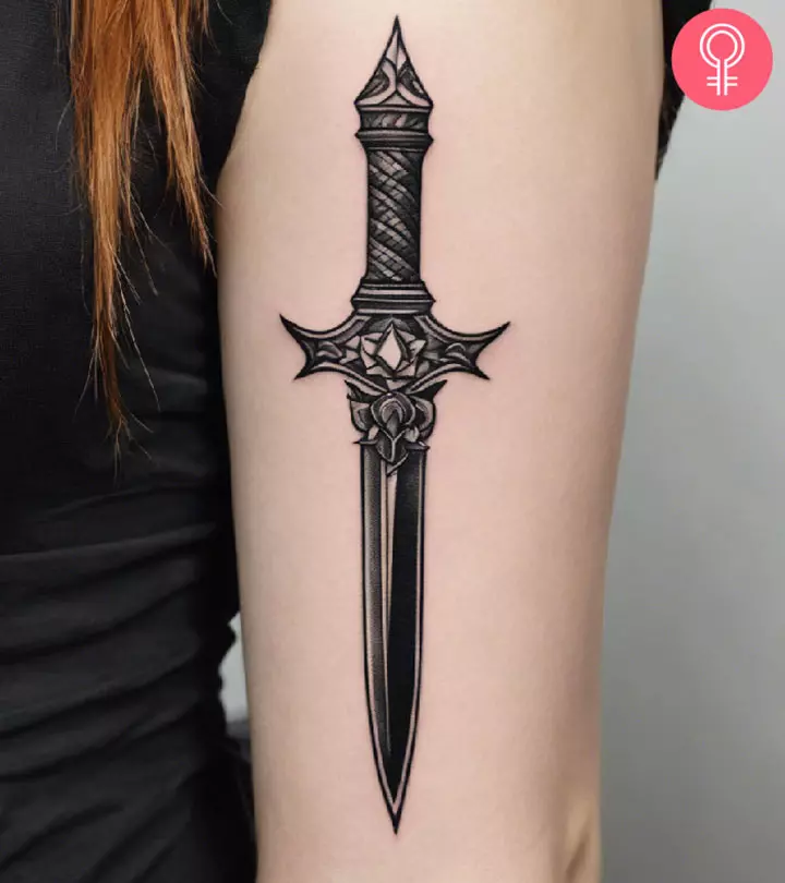 A woman with a dagger tattoo on her upper arm