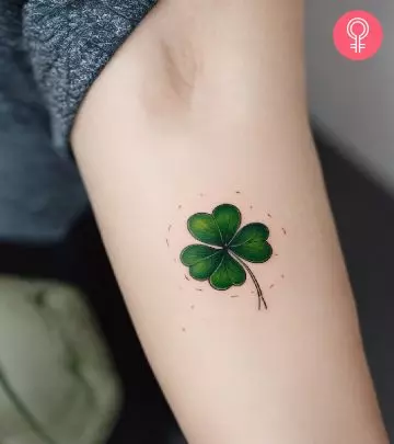 Woman with a thistle tattoo on the upper arm