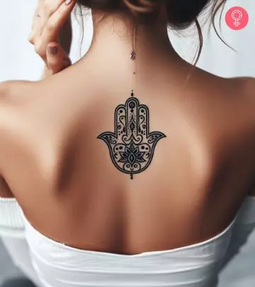 A mandala lotus flower tattoo on a woman’s forearm