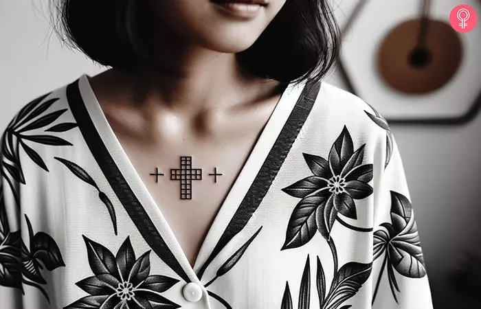 A 3-cross tattoo on the chest of a woman