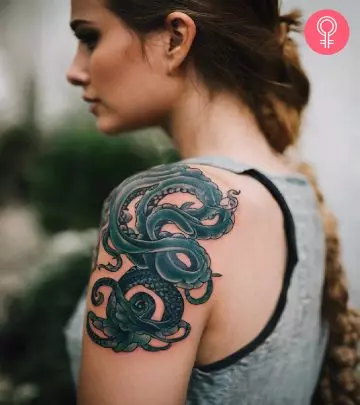 Woman with a beach tattoo on her upper arm