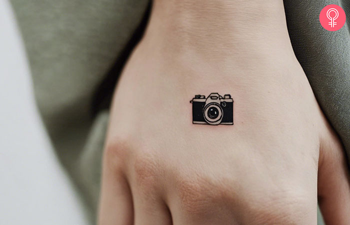 A camera tattoo on the back of the hand