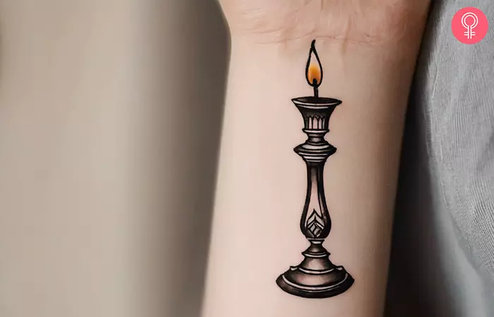 A candlestick tattoo on the wrist