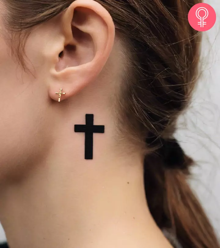 A cross tattoo behind ear
