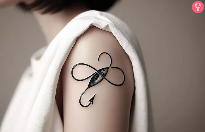 A fish hook tattoo with the infinity symbol 