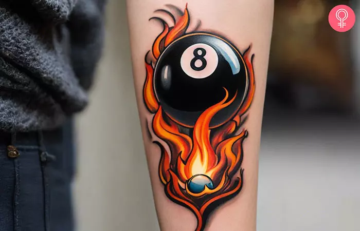 A flaming 8 ball tattoo on the arm