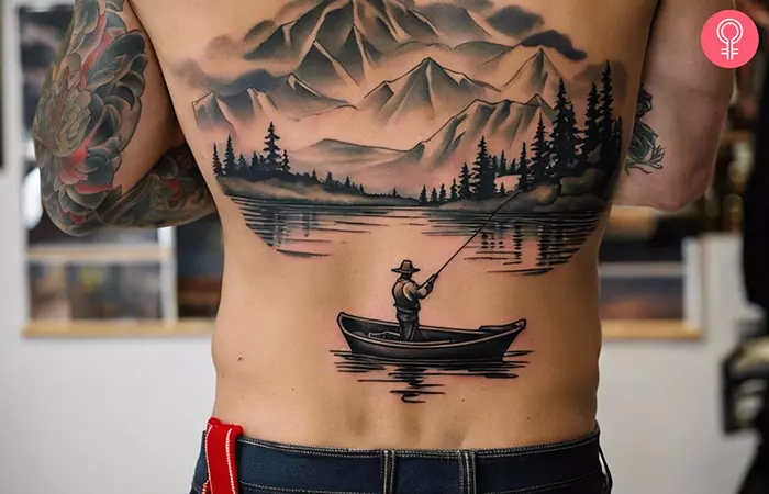 A large back tattoo showing a man fishing