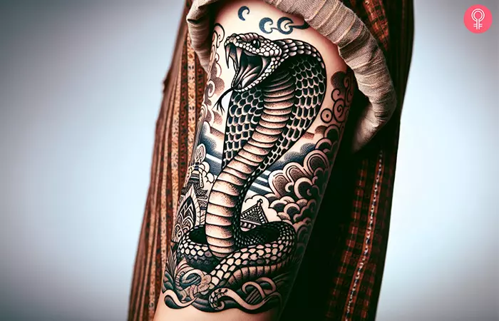 A large king cobra tattoo on the upper arm
