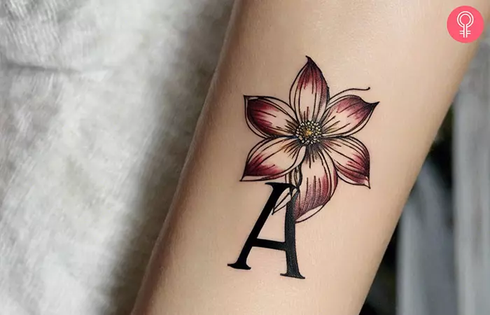 A letter A tattoo on a woman’s forearm