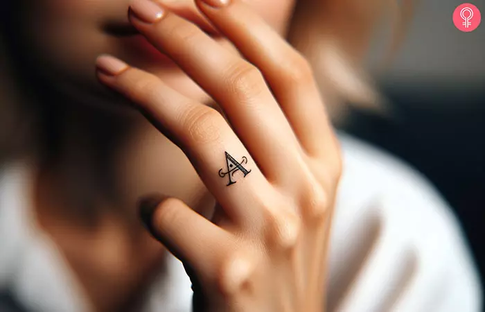 A letter A tattoo on a woman’s ring finger