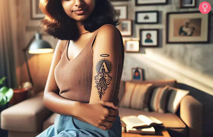 A letter A with a halo tattoo on a woman’s forearm