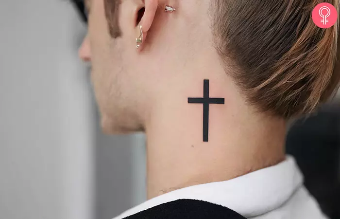 A neck cross tattoo behind the ear