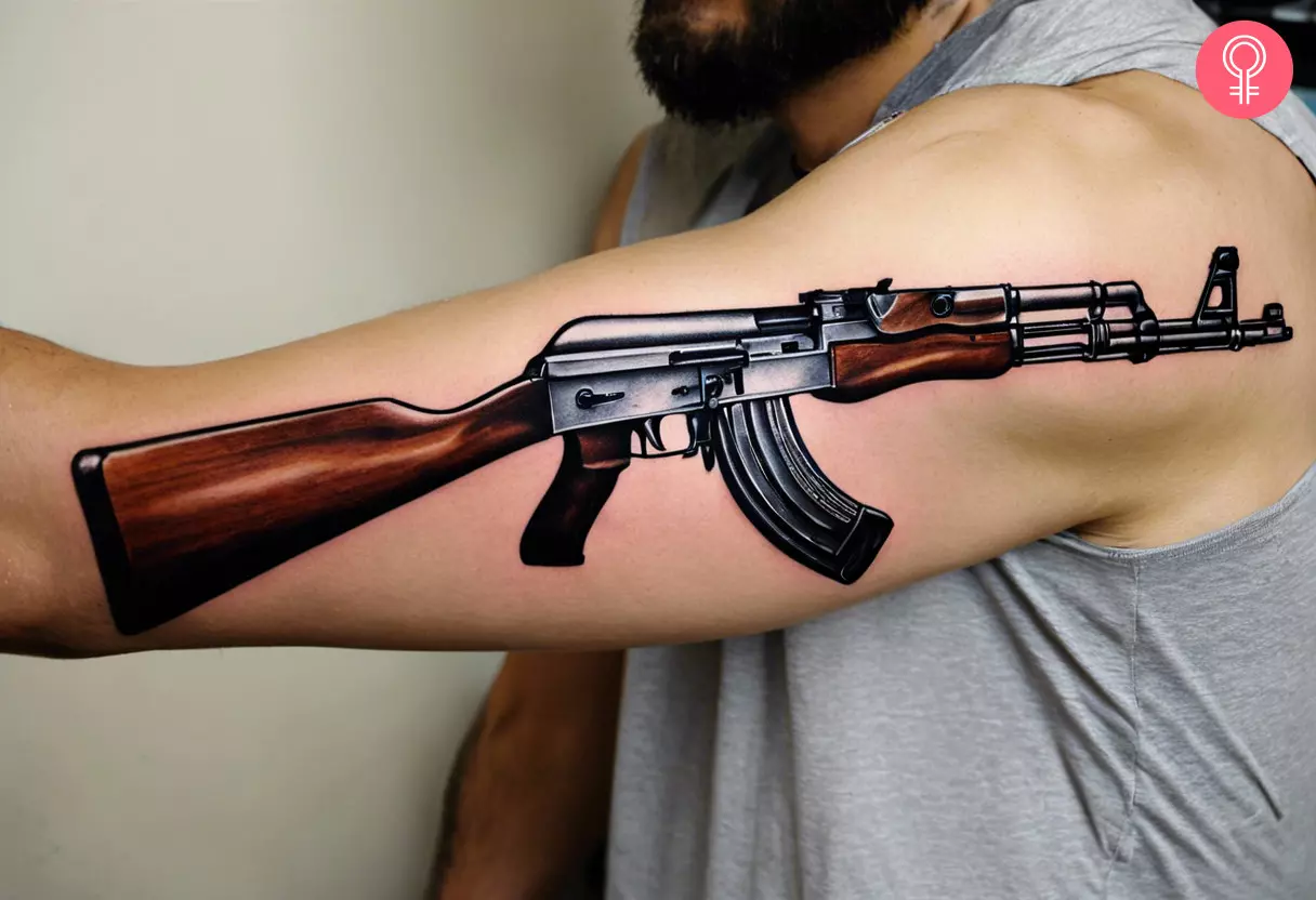 A realistic AK-47 coving the upper arm and the back area of the shoulder