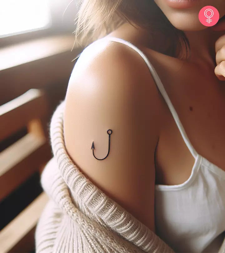 A simple fish hook tattoo on the arm