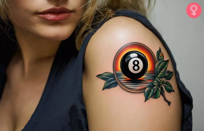 A traditional 8 ball tattoo on the arm