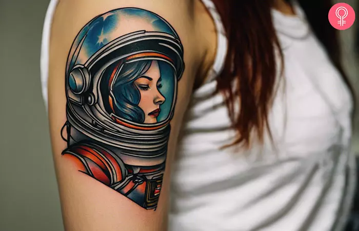 A traditional astronaut tattoo on a woman’s upper arm
