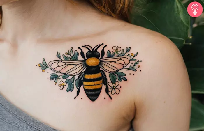 A wildflower and bee tattoo on the chest