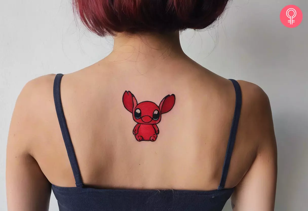 A woman flaunting a funny cute red stitch tattoo on the back