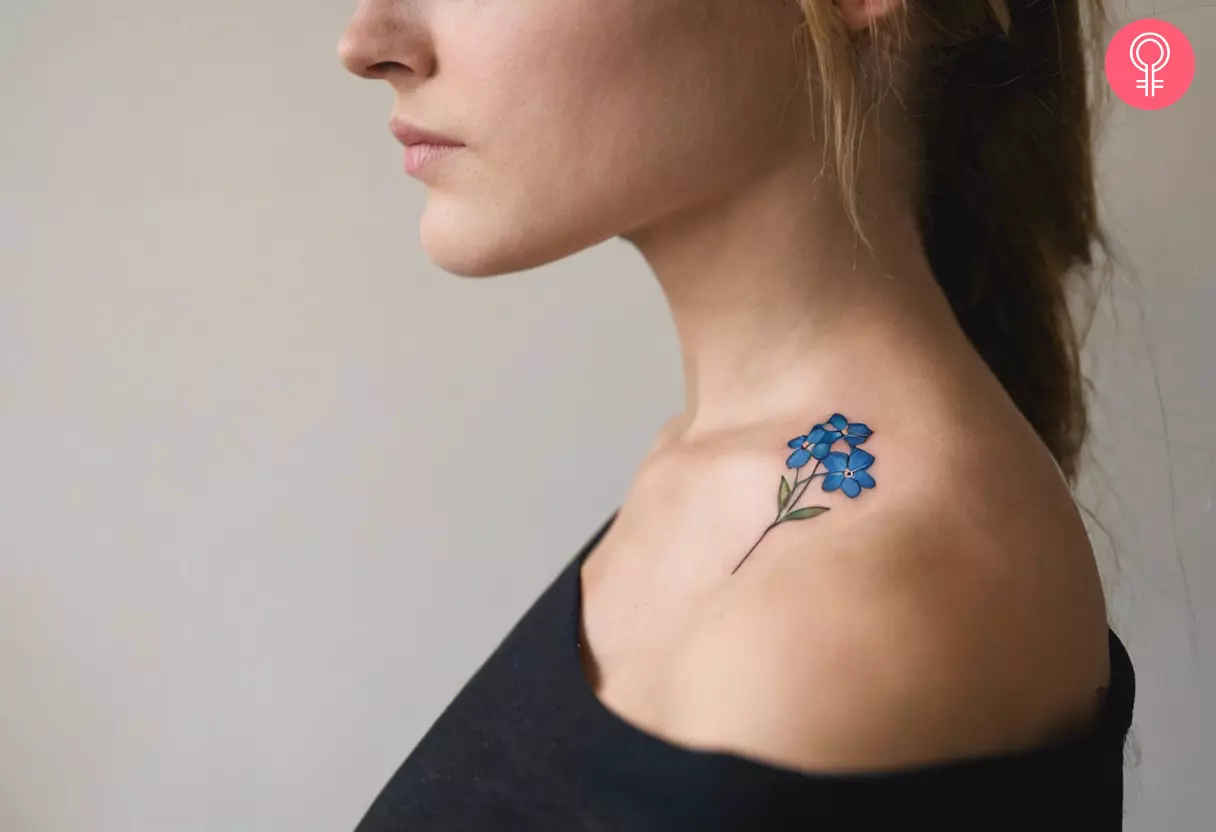 A woman showing a forget me not tattoo on her neck