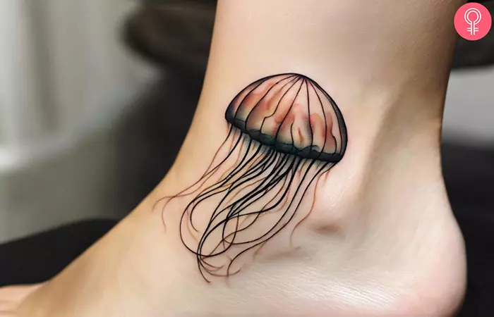 A woman showing a jellyfish tattoo on the ankle
