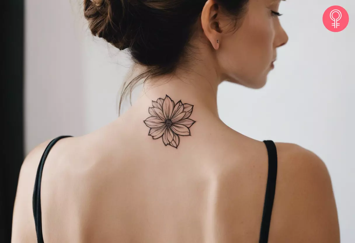 A woman sporting a tattoo on the back of her neck