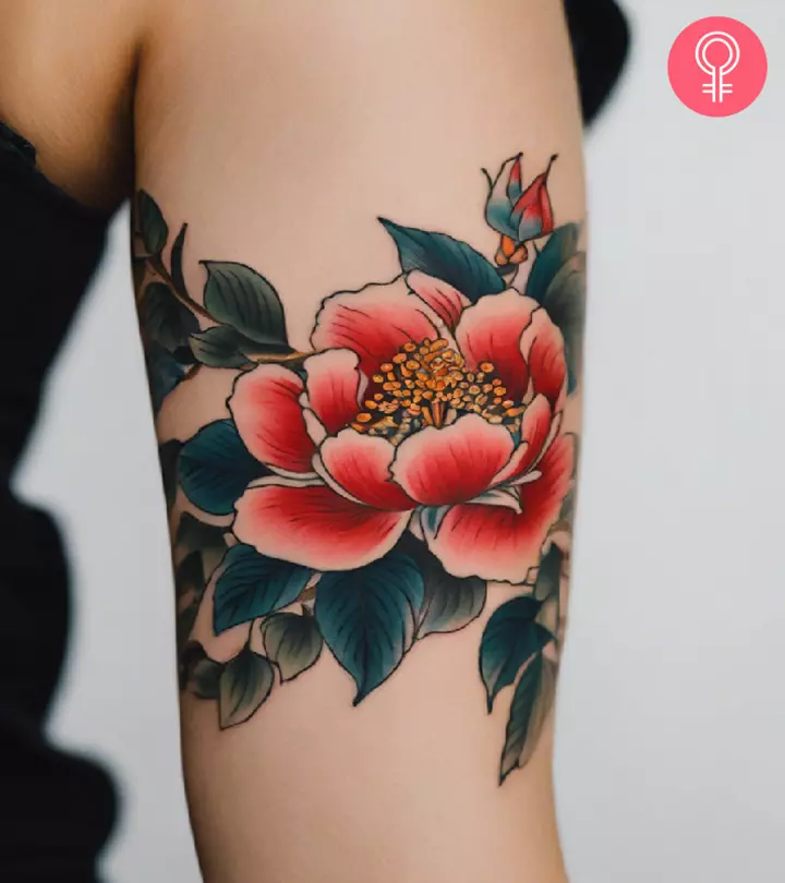A woman with a Chinese flower tattoo on her upper arm