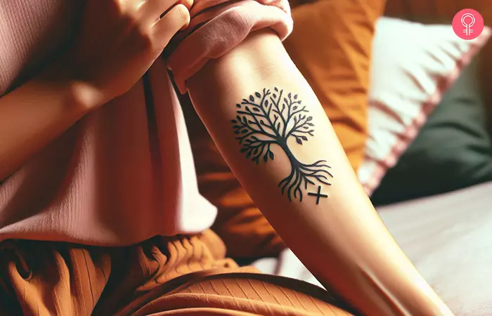 A woman with a Yggdrasil with runes tattoo on her arm