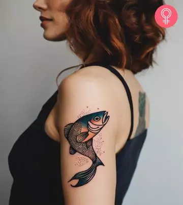 A pretty watercolor fish tattoo on the upper arm