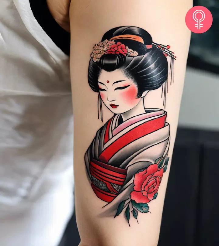 A woman with a geisha tattoo on her upper arm