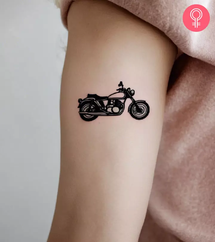 A woman with a motorcycle tattoo on the arm