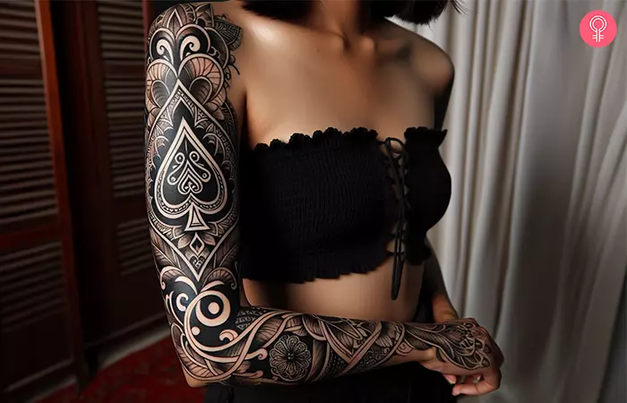  A woman with an ace of spades sleeve tattoo design 