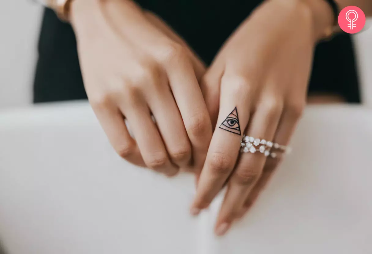 All-seeing eye tattoo on the finger