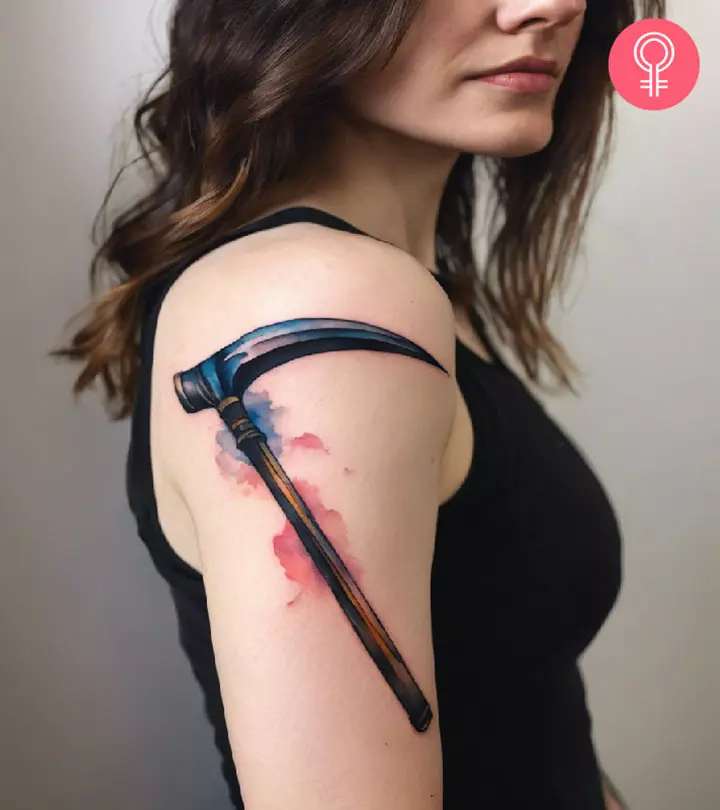 A watercolor scythe on the upper arm