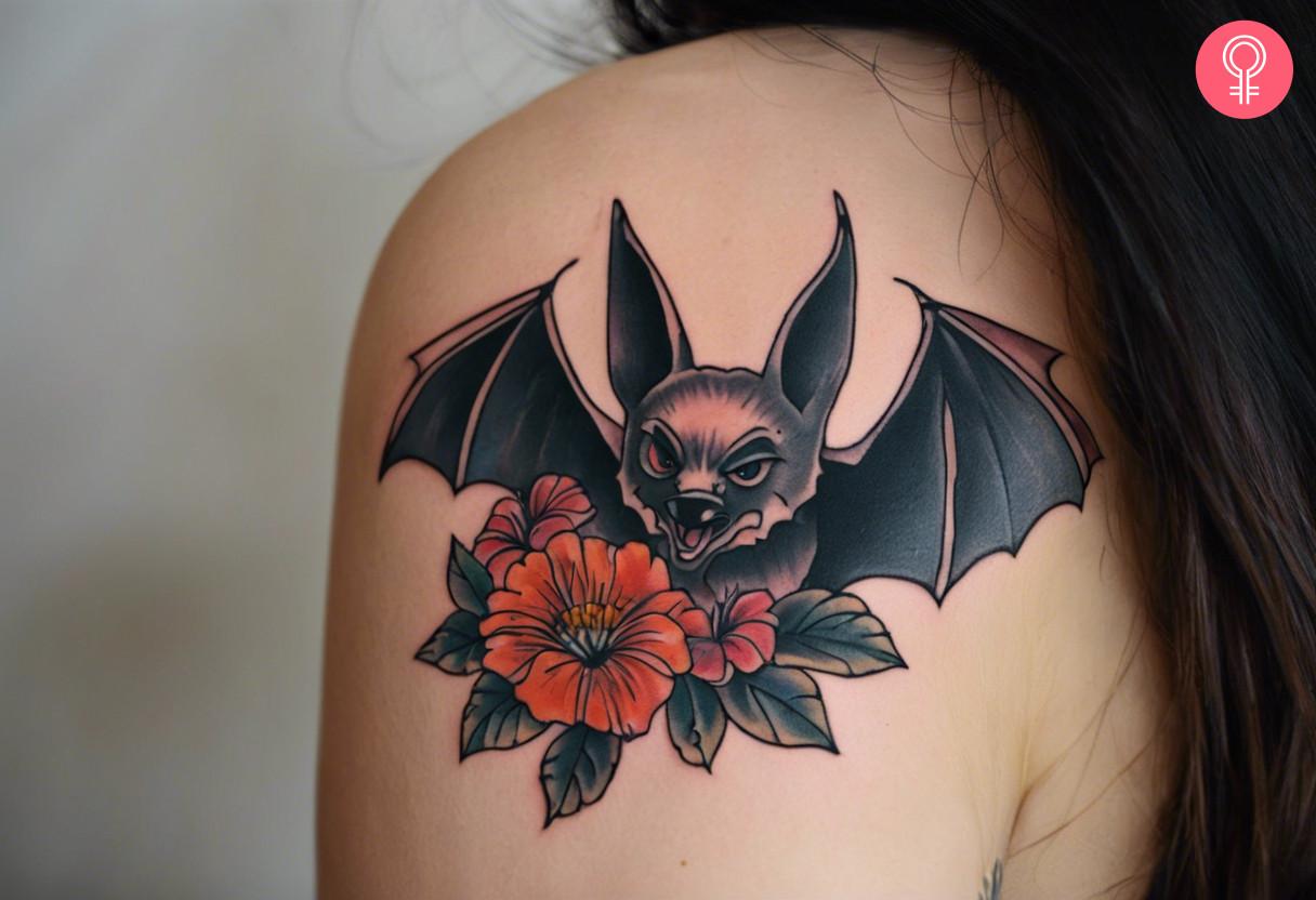 American traditional bat tattoo on a woman’s shoulder